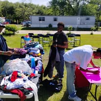Neighbors selecting donated clothing at the outreach