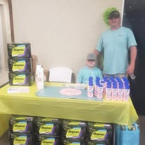 Volunteers staffing a personal-care distribution table