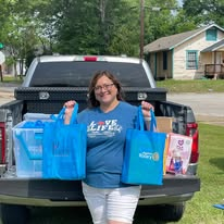 A volunteer delivering bags of outreach supplies
