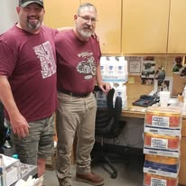 Volunteers with stacked boxes of donated supplies