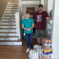 Volunteers with personal-care products and donated boxes