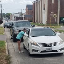 A volunteer serving a driver during a church outreach