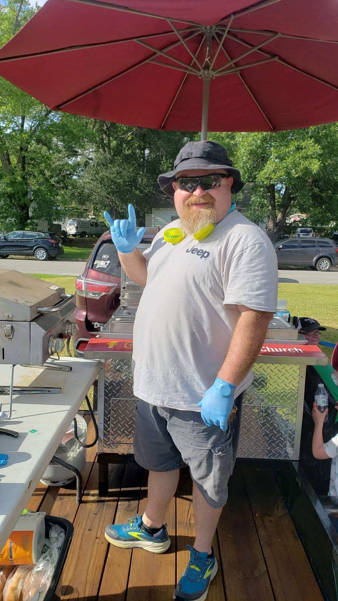 A volunteer working beside the Brothers Keeper grill
