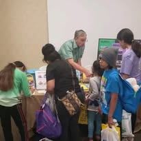 Volunteers helping families select donated supplies