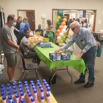 Volunteers helping guests at an indoor supply distribution