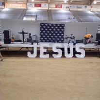 A ministry stage displaying the name Jesus