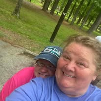 Two volunteers smiling together in the park