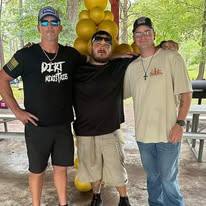 Three men serving together at the outreach