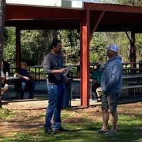 Two people sharing a personal conversation near the pavilion