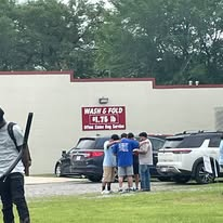 A small group praying together near the outreach