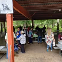 Guests and volunteers gathering at the outreach pavilion