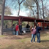 Volunteers standing near a busy outreach pavilion