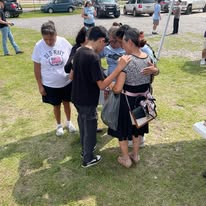 People offering prayer and personal care during a homeless outreach