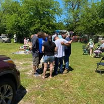 A prayer circle in the park during community outreach