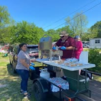 Volunteers preparing and serving hot food