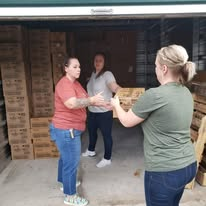 Volunteers passing donated supplies through a storage unit