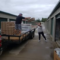 Volunteers unloading a trailer filled with donation boxes