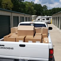 A pickup truck filled with boxes of outreach supplies