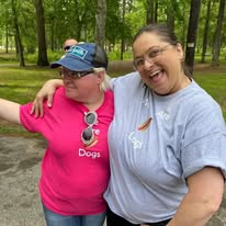 Two outreach volunteers sharing a joyful moment