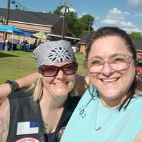 Two smiling volunteers at the outdoor outreach