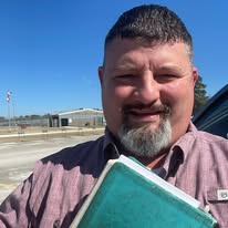Jeremy Sanford holding his Bible outside the unit