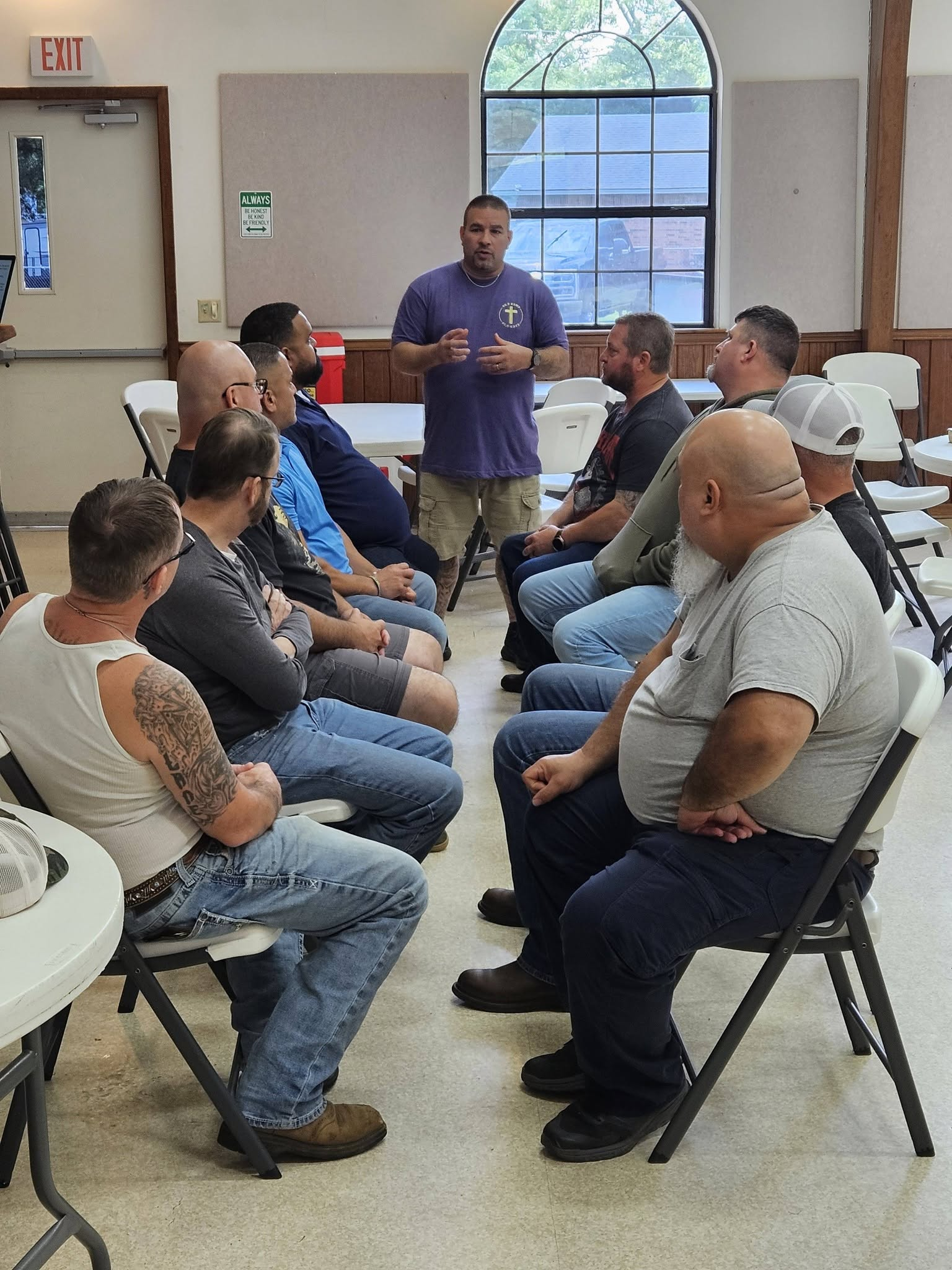 A ministry leader teaching and encouraging a circle of volunteers